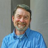 Brian Bay in front of a white wall