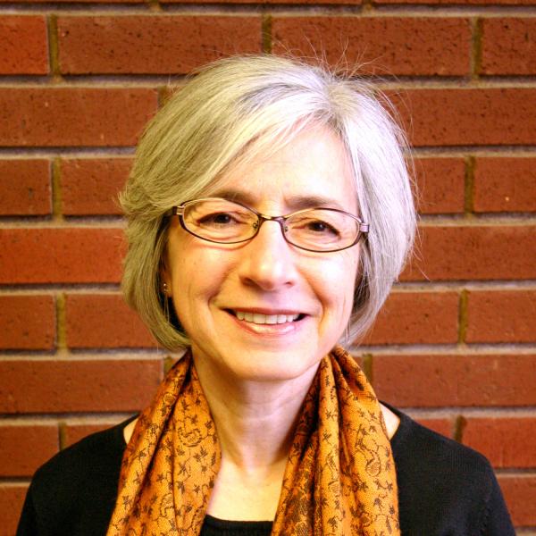 Anita Guerrini in front of a brick wall