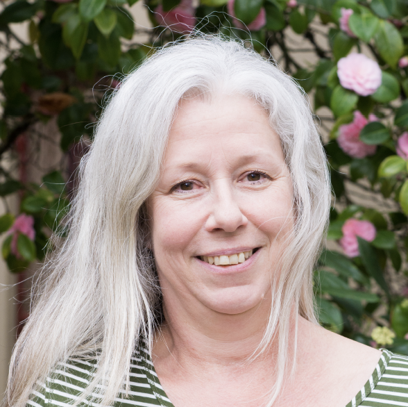 Ann Sitomer in front of flowers