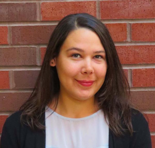 Andrea Goering in front of a brick wall