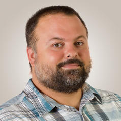 Dave Hendrix in front of a gray background