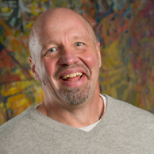 Patrick Ball in front of a colorful background